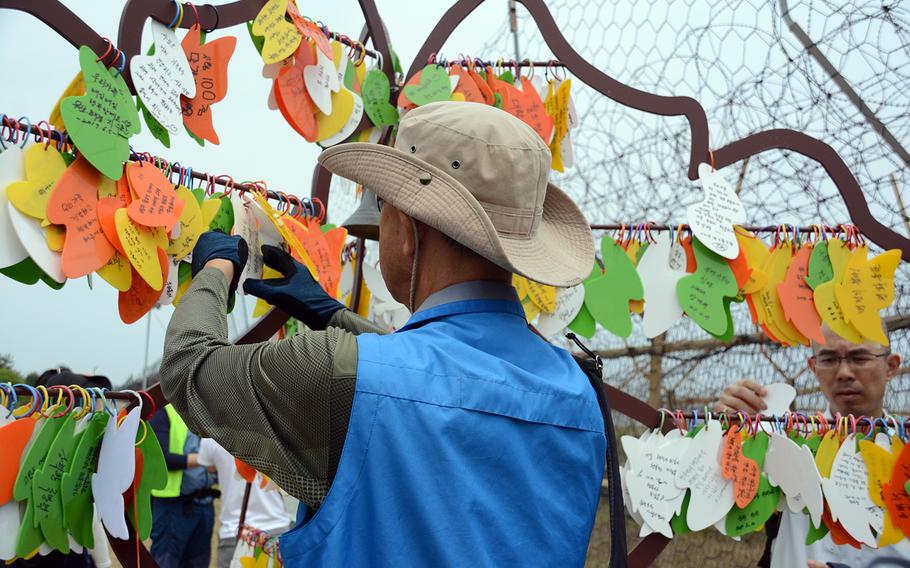 South Koreans place wishes for peace on a tree of hope erected on the Goseong DMZ Peace Trail, which was recently opened to civilians in the northeastern part of the heavily fortified border area. About 20 South Koreans participated in a hike on Friday, June 14, 2019.