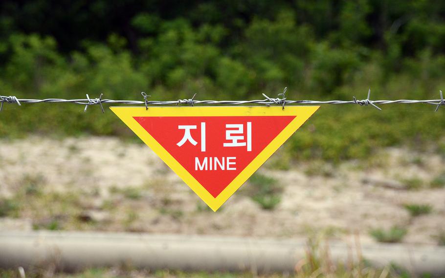 A sign warns of mines, a reminder of the dangers for hikers on the Goseong DMZ Peace Trail, which was recently opened to civilian hikers in the northeastern part of the heavily fortified border area. About 20 South Koreans participated in a hike on Friday, June 14, 2019.