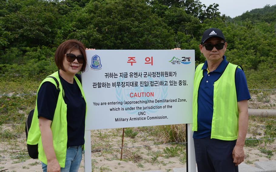 A couple poses in front of a sign during a hike on Friday, June 14, 2019, on the Goseong DMZ Peace Trail, which was recently opened to civilians in the northeastern part of the heavily fortified border area.