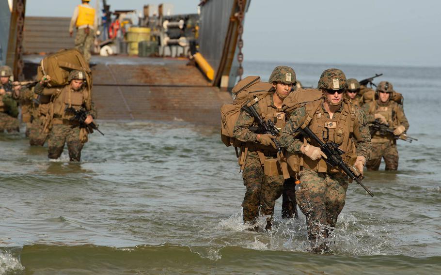 Marines with 22nd Marine Expeditionary Unit march to the beach from a Landing Craft Utility boat as part of preparation for an amphibious assault in support of exercise BALTOPS 2019 at Klaipeda, Lithuania, June 15, 2019.