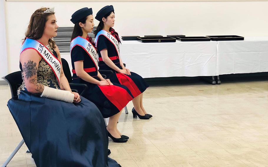 Airman 1st Class Brooklyn Shedd, an air and space propulsionist assigned to Misawa Air Base, Japan, sits alongside her fellow Misawa Queens after being crowned in Misawa, Japan, Friday, June 21, 2019.