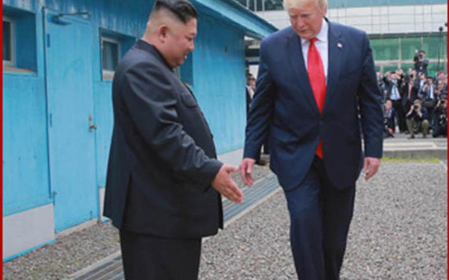 North Korean leader Kim Jong Un ushers President Donald Trump across the berm marking the line between North and South Korea on Sunday, June 30, 2019.