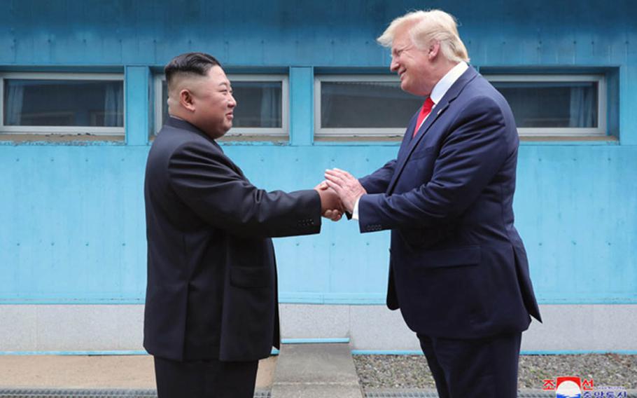 North Korean leader Kim Jong Un and U.S. President Donald Trump shake hands across the line separating North and South Korea on Sunday, June 30, 2019.