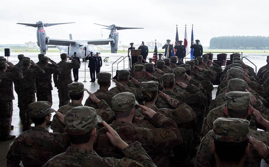 Airmen from the newly activated 21st Special Operations Squadron and the 753rd Special Operations Maintenance Squadron salute the flag during the activation ceremony for both commands on Yokota Air Base, Japan,  Monday, July 1, 2019.