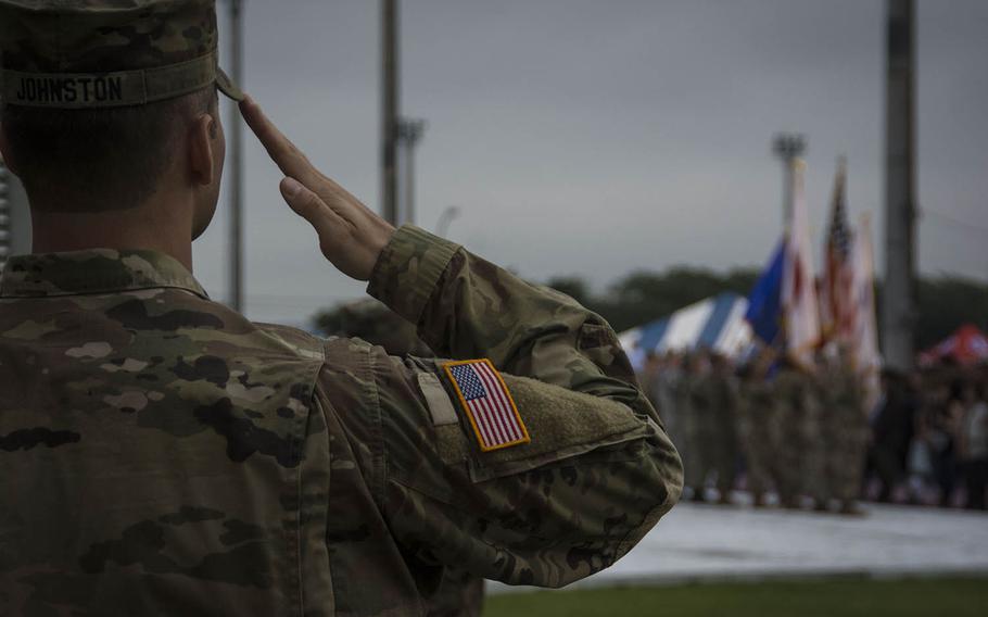 Sgt. Lucas Johnston salutes the flag during an Independence Day celebration at Camp Zama, near Tokyo, Saturday, June 29, 2019.