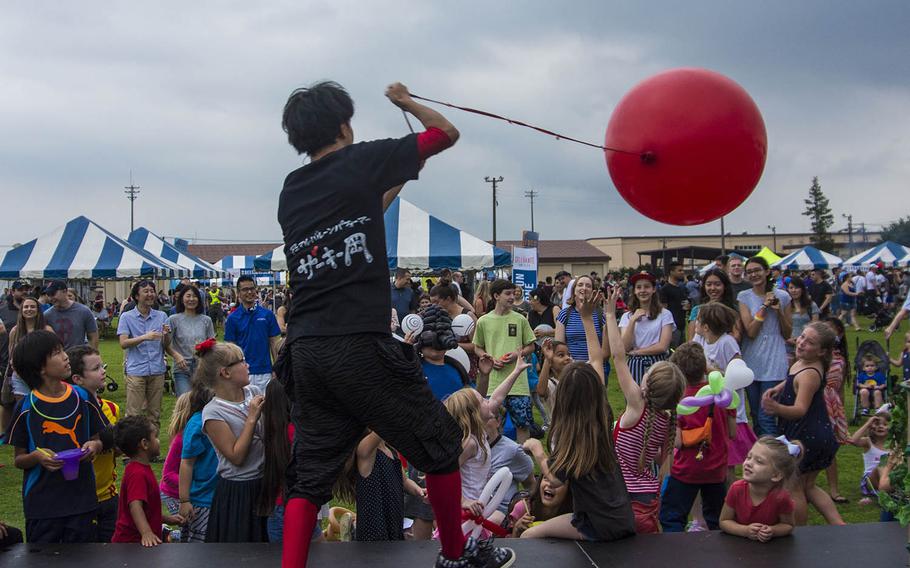 A balloonist entertains children during the Celebrate America festival at Yokota Air Base, Japan, Wednesday, July 3, 2019.