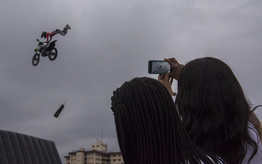 People watch a freestyle motocross demonstration during the Celebrate America festival at Yokota Air Base, Japan, Wednesday, July 3, 2019.