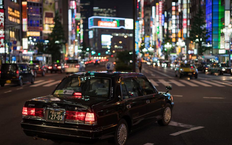 A taxi waits at a stoplight in Tokyo's Shinjuku ward in this undated photo.