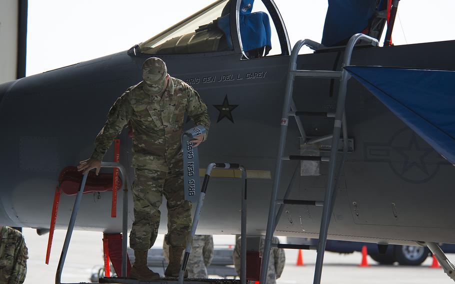 The name of the outgoing 18th Wing commander, Brig. Gen. Case Cunningham, is replaced on an aircraft by that of the new commander, Brig. Gen. Joel Carey, at Kadena Air Base, Okinawa, Monday, July 8, 2019.