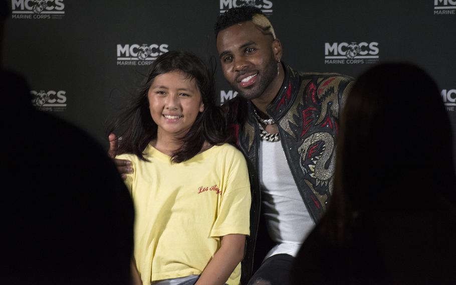 Musician Jason Derulo poses with a young fan at Camp Foster, Okinawa, Japan, Saturday, July 6, 2019.
