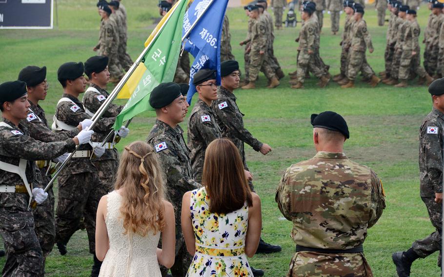 Maj. Gen. Steve Gilland stands with his wife, Betsy, and their daughter during the pass and review after assuming command of the 2nd Infantry Division at Camp Humphreys, South Korea, Wednesday, July 17, 2019.