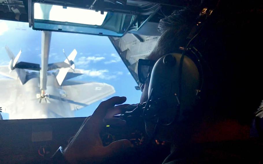 Air Force Tech. Sgt. Dave Pingleton, a boom operator, refuels an F-22 Raptor from a KC-10 Extender during a Talisman Sabre drill over the Coral Sea, Friday, July 19, 2019.