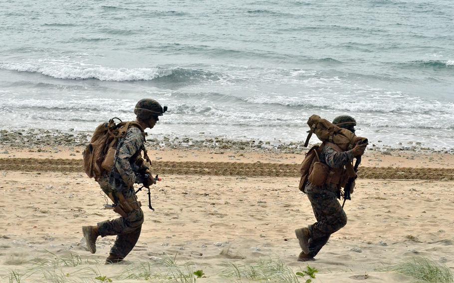 U.S. Marines run along Kings Beach near the Australian town of Bowen during a Talisman Sabre drill, Monday, July 22, 2019.