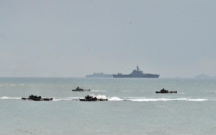 U.S. Marine Corps amphibious-assault vehicles approach Kings Beach near the Australian town of Bowen during a Talisman Sabre drill, Monday, July 22, 2019.