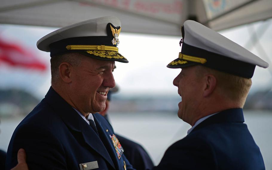 Adm. Karl Schultz, left, is greeted by Capt. Matthew Meilstrup aboard the U.S. Coast Guard tall ship Eagle on June 6, 2019.