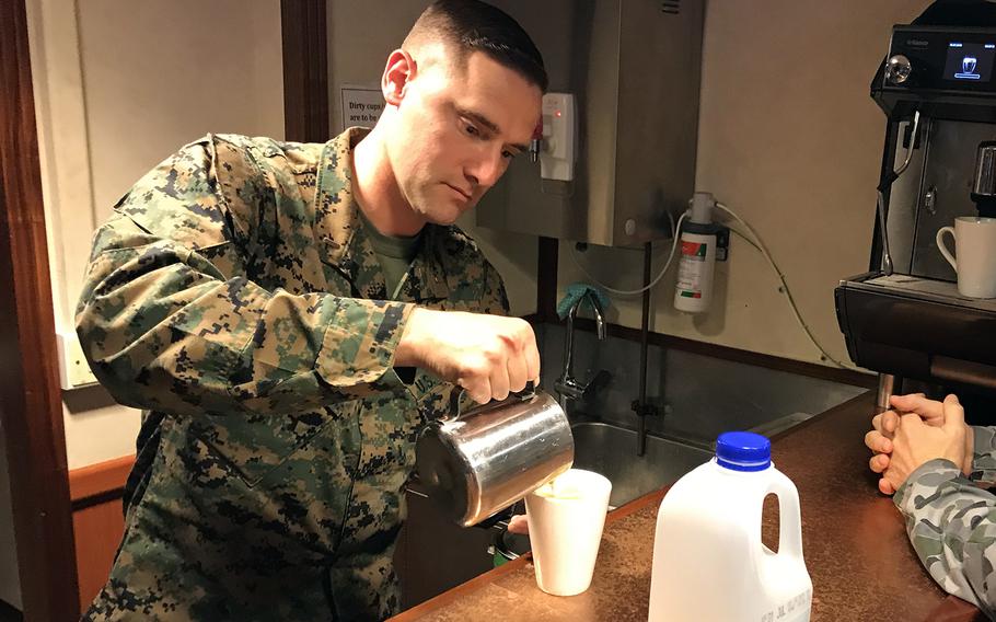 Marine Corps Lt. Joshua Ley pours a cup of coffee aboard the HMAS Adelaide in the Coral Sea on Tuesday, July 16, 2019.