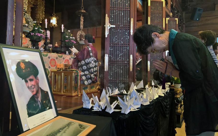 A local resident prays during a service for U.S. airmen downed in World War II during a memorial service in western Hiroshima on Saturday, July 27, 2019.