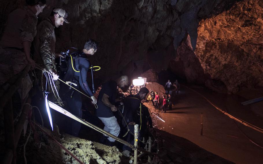 Air Force Tech Sgt. Kenny O'Brien, third from left, descends into Tham Luang cave in Chiang Rai, Thailand, ahead of dive operations on July 2, 2018.
