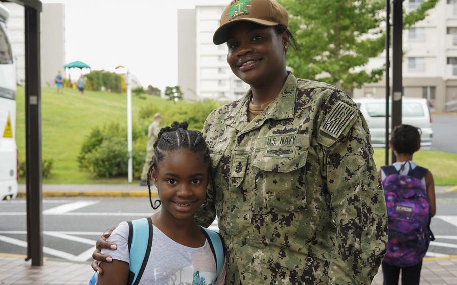 Senior Chief Petty Officer Cleopatra Bell poses outside Sullivans Elementary School with her daughter, third-grader Jazlyn Bell, at Yokosuka Naval Base,Japan, Monday, Aug. 26, 2019.