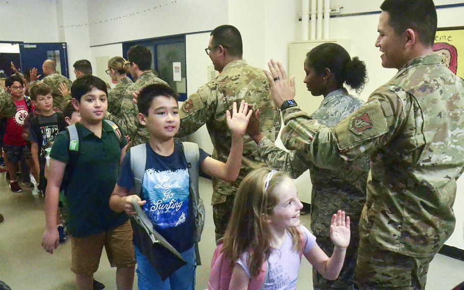 Airmen from the 374th Medical Group greet children at Joan K. Mendel Elementary School on Yokota Air Base, Japan, Monday, Aug. 26, 2019.