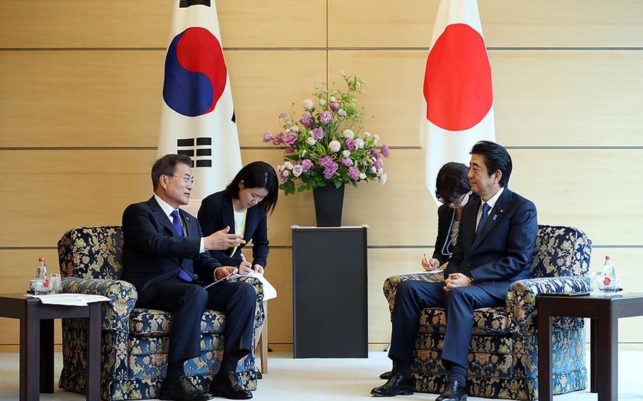 South Korean President Moon Jae-in, left, meets with Japanese Prime Minister Shinzo Abe in May 2018 before relations between the neighboring countries deteriorated this year.