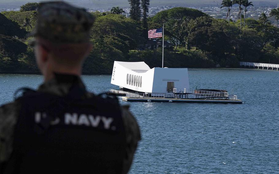 A sailor stands watch as the USS Boxer passes the USS Arizona Memorial in Pearl Harbor, Hawaii, May 16, 2019.