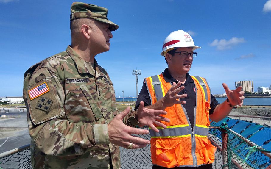 Maj. Gen. Anthony Funkhouser, left, U.S. Army Corps of Engineers deputy commander, checks out the dredging of a military port in Naha, Japan, August 29, 2019.