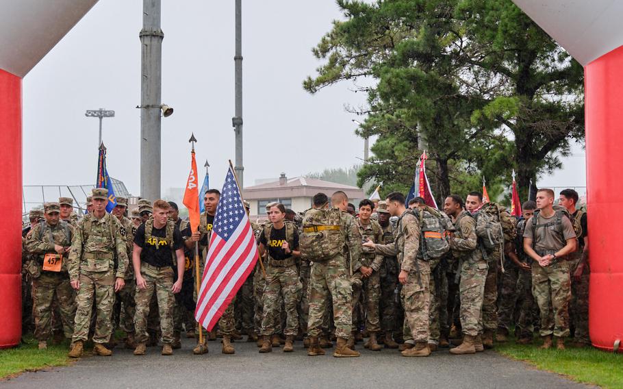 Soldiers wait at the starting line during the ninth annual 9/11 Memorial Ruck March at Camp Humphreys, South Korea, Wednesday, Sept. 11, 2019.