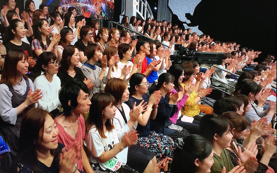 A studio audience listens to a group from the U.S. Air Force Band of the Pacific during a live broadcast of the Japanese TV show, "Nodojiman The World!" in Tokyo on Wednesday, Sept. 11, 2019.