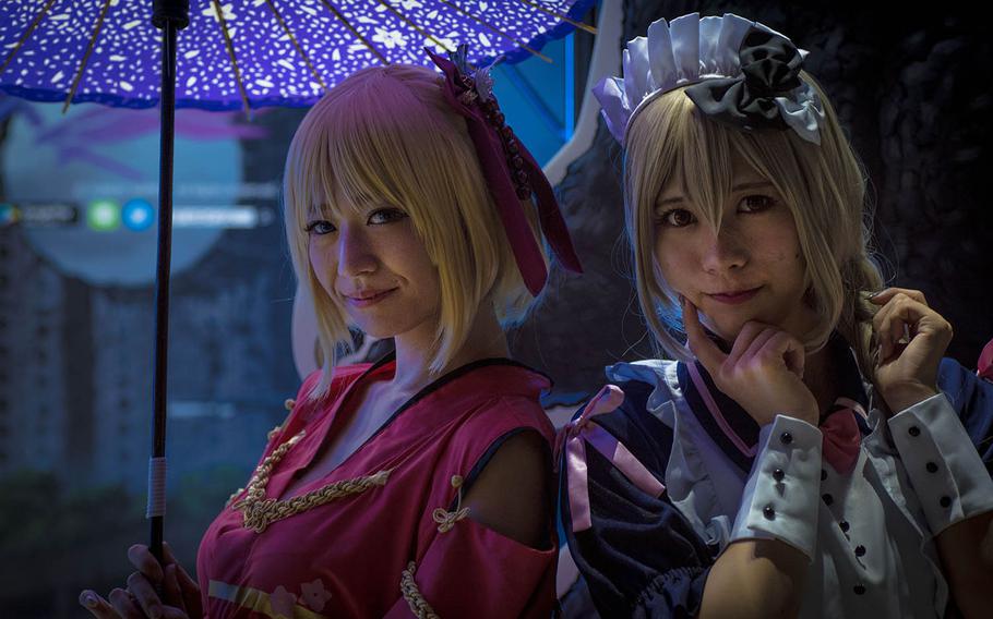 Cosplay models stand in front of a vendor booth at the Tokyo Game Show 2019 on Thursday, Sept. 12, 2019.