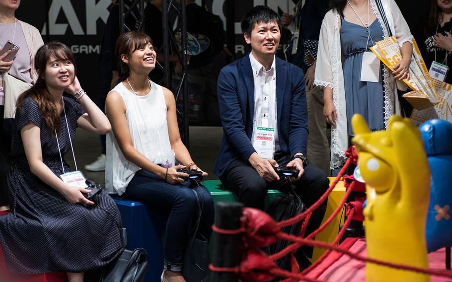 Attendees of the Tokyo Game Show 2019 play a game at an indie game development booth on Thursday, Sept. 12, 2019.