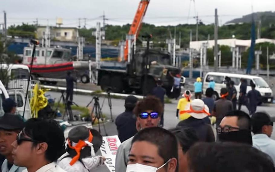 A screenshot from a YouTube video shows demonstrators gathered to oppose the Marine Corps launching a small craft from Motobu Port on Okinawa, Japan, on Tuesday, Sept. 18, 2019.