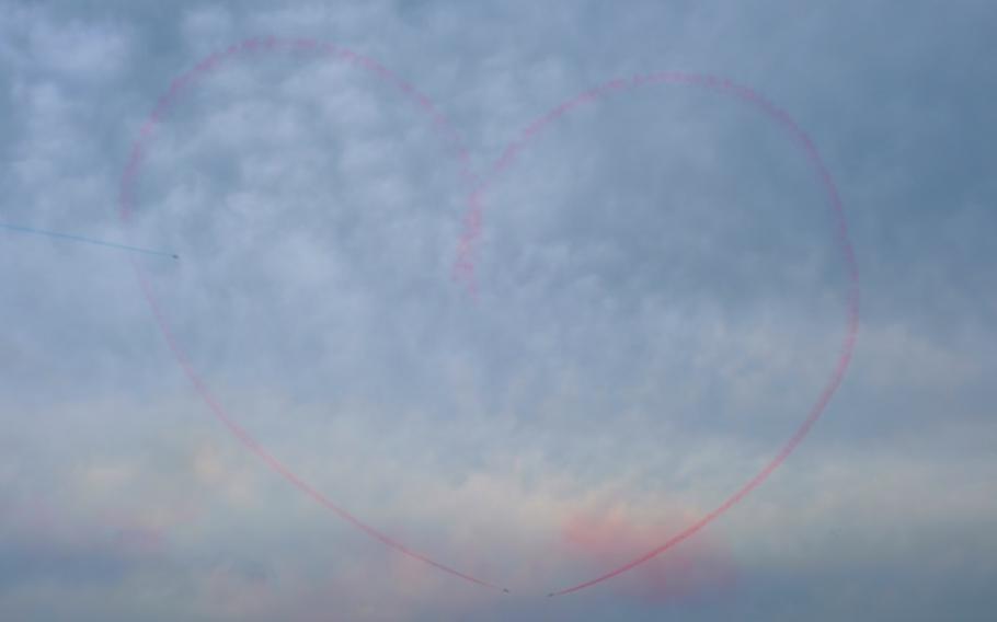 Members of South Korea's Black Eagles aerobatics team draw a pierced heart in the sky during Air Power Day at Osan Air Base, South Korea, Friday, Sept. 20, 2019.