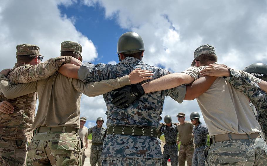 Members of the U.S. Air Force and Japan Air Self-Defense Force huddle up prior to an exercise at Naha Air Base, Japan, Aug. 30, 2019.