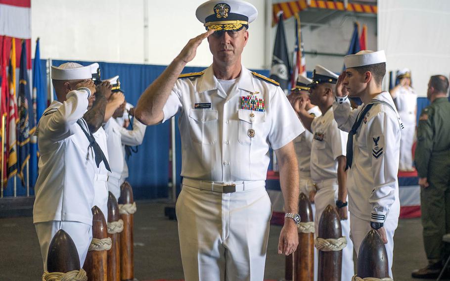 Rear Adm. George M. Wikoff exits the stage after taking command of Task Force 70 aboard the USS Ronald Reagan in the South China Sea on Sunday, Sept. 29, 2019.