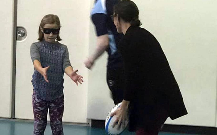 Students at Yokota West Elementary School at Yokota Air Base, Japan, tried passing and catching rugby balls while wearing glasses that simulate visual impairments, Wednesday, Oct. 16, 2019.