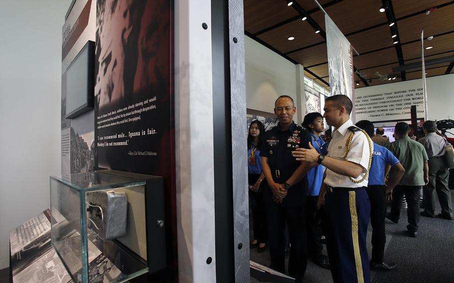 Guests check out a new visitor center that opened Sunday, Oct. 20, 2019, at the Manila American Cemetery, where more than 17,000 service members who lost their lives in World War II are interred.