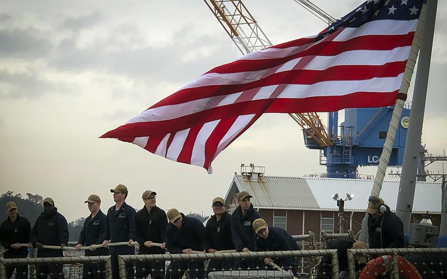 Sailors aboard the USS John S. McCain return to Yokosuka Naval Base, Japan, Sunday, Nov. 3, 2019, after the ship's first sea trials since a deadly collision in August 2017.