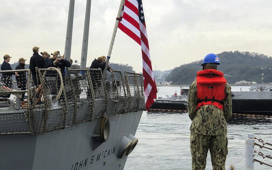 Sailors aboard the USS John S. McCain guide the ship to a berth at Yokosuka Naval Base, Japan, Sunday, Nov. 3, 2019, after a week of sea trials.