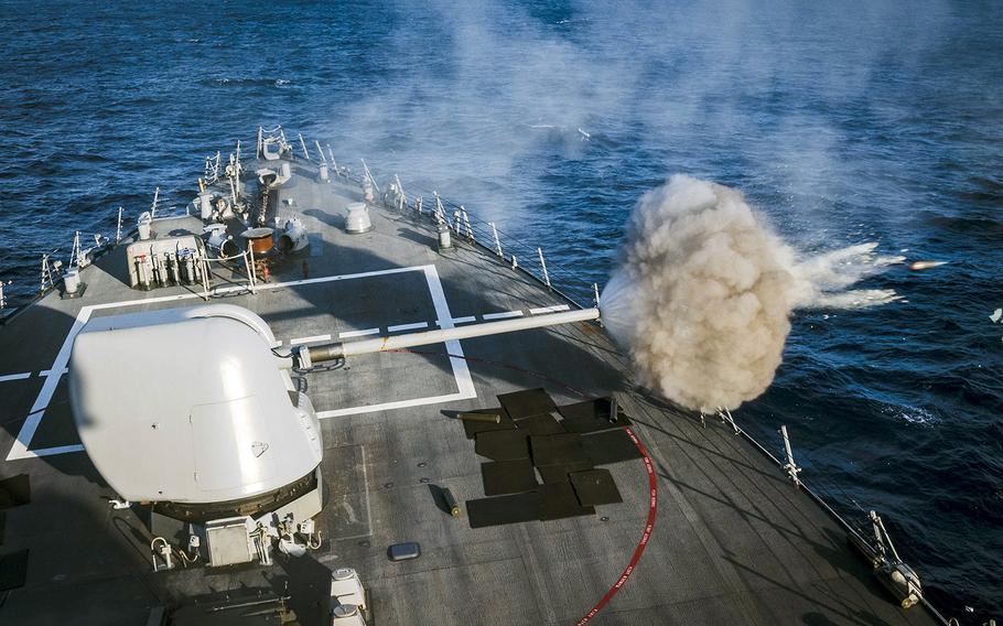 The guided-missile destroyer USS John S. McCain fires its 5-inch gun during a live-fire exercise in the Philippine Sea, Wednesday, Oct. 30, 2019.