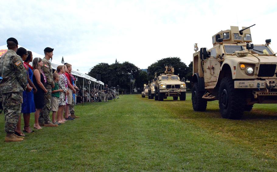 Maj. Gen. James Jarrard, new commander of the 25th Infantry Division, stands with his family for a pass in review during a change-of-command ceremony at Schofield Barracks, Hawaii, Tuesday, Nov. 5, 2019.