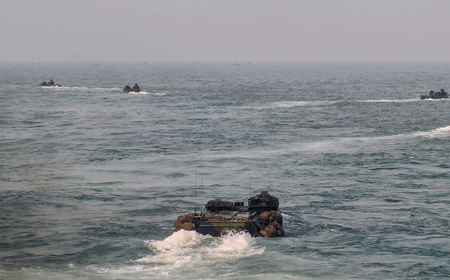 U.S. assault amphibious vehicles depart the dock landing ship USS Germantown for a beach landing during exercise Tiger Triumph in the Bay of Bengal, India, Nov. 19, 2019.