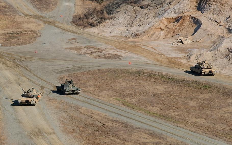 M1 Abrams tanks from the Army's 3rd Armored Brigade Combat Team and a T-80U tank from South Korea's 3rd Armored Brigade conduct a live-fire battle exercise at Rodriguez Live Fire Range in Pocheon, South Korea, Tuesday, Nov. 19, 2019.