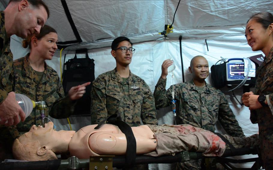 Navy doctors and hospital corpsmen assigned to the 3rd Medical Battalion work on a simulated casualty inside a Role 2 field hospital at Camp Hansen, Okinawa, Thursday, Nov. 21, 2019.