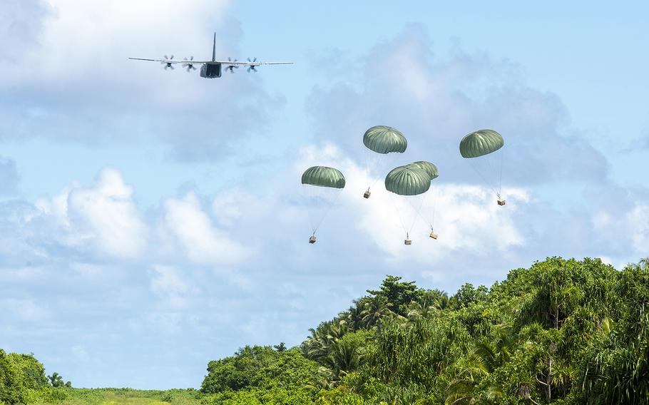 An Air Force C-130J Super Hercules out of Yokota Air Base, Japan, delivers bundles filled with critical supplies to the island of Woleai, Micronesia, during Operation Christmas Drop, Tuesday, Dec. 10, 2019.