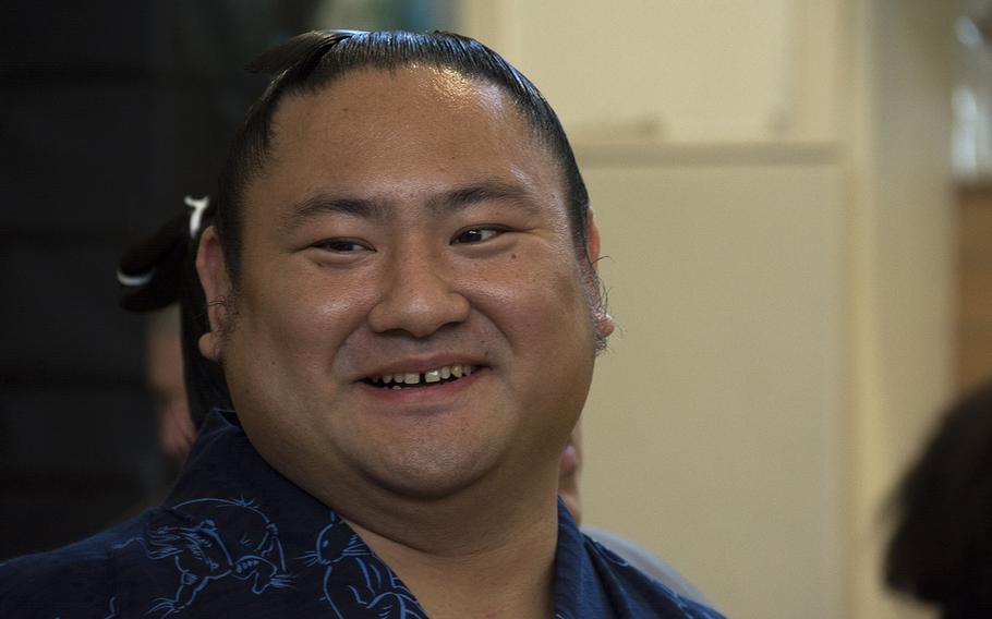 Japanese sumo wrestler Kotoeko speaks with staff at Lester Middle School on Camp Lester, Okinawa, Friday, Dec. 13, 2019.