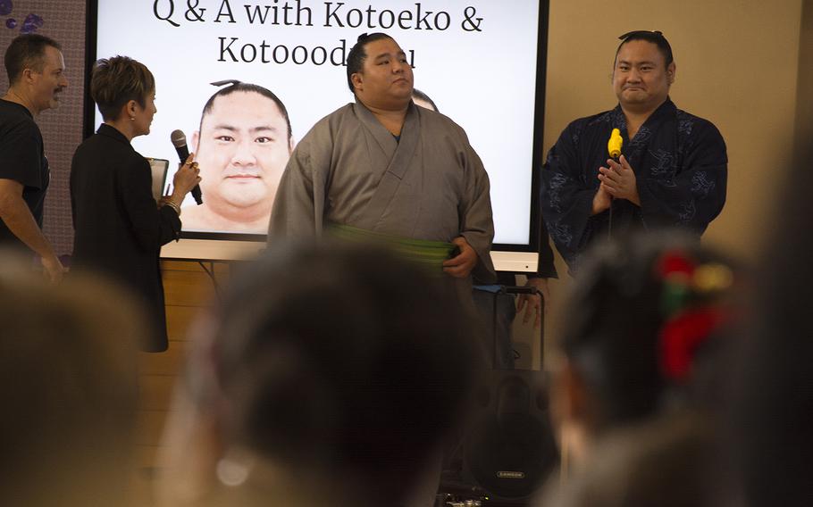 Japanese sumo wrestlers Kotoeko, far right, and Kotooodutsu answer questions from students at Lester Middle School on Camp Lester, Okinawa, Friday, Dec. 13, 2019.
