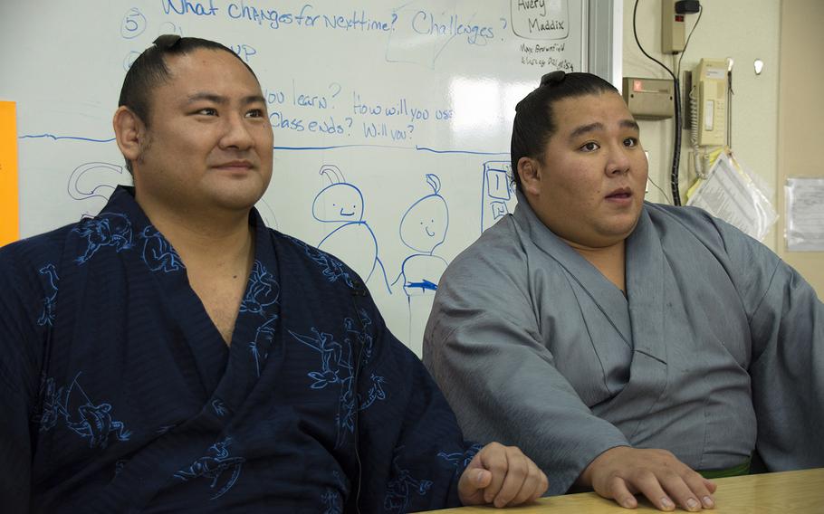 Japanese sumo wrestlers Kotoeko, left, and Kotooodutsu answer questions at Lester Middle School at Camp Lester, Okinawa, Friday, Dec. 13, 2019.