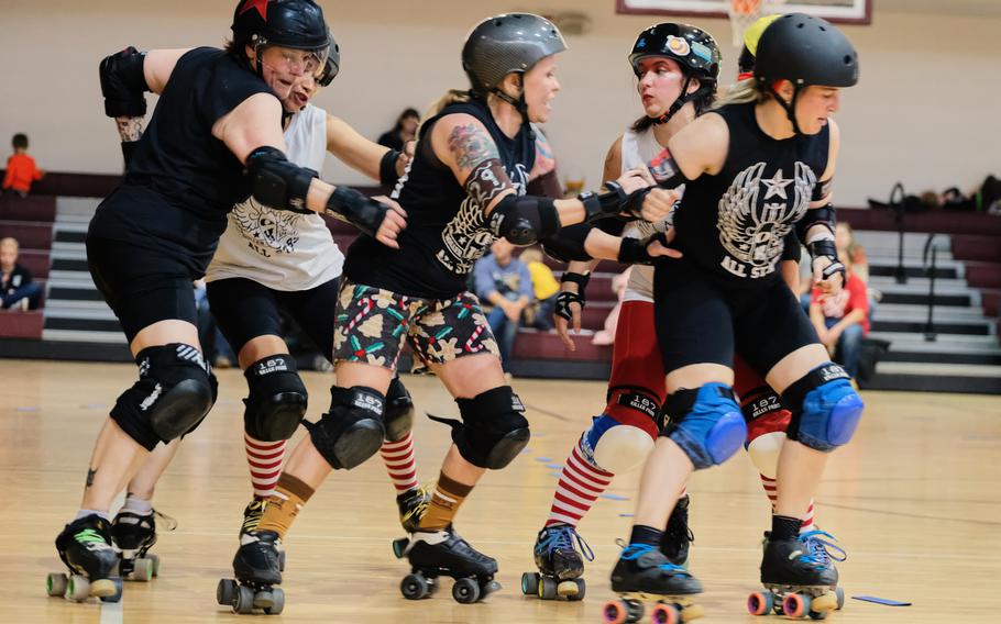The Gingerbread Brawlers and Candy Cane Crushers compete in a roller derby scrimmage at Collier Community Fitness Center on Camp Humphreys, South Korea, Saturday, Dec. 14, 2019.