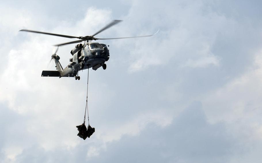 A Navy MH-60R Seahawk from Helicopter Maritime Strike Squadron 37 carries pallets over the South China Sea,  May 7, 2019. One of the squadron's Seahawks was used to airlift an ill cruise ship passenger to Hawaii on Jan. 1, 2020.